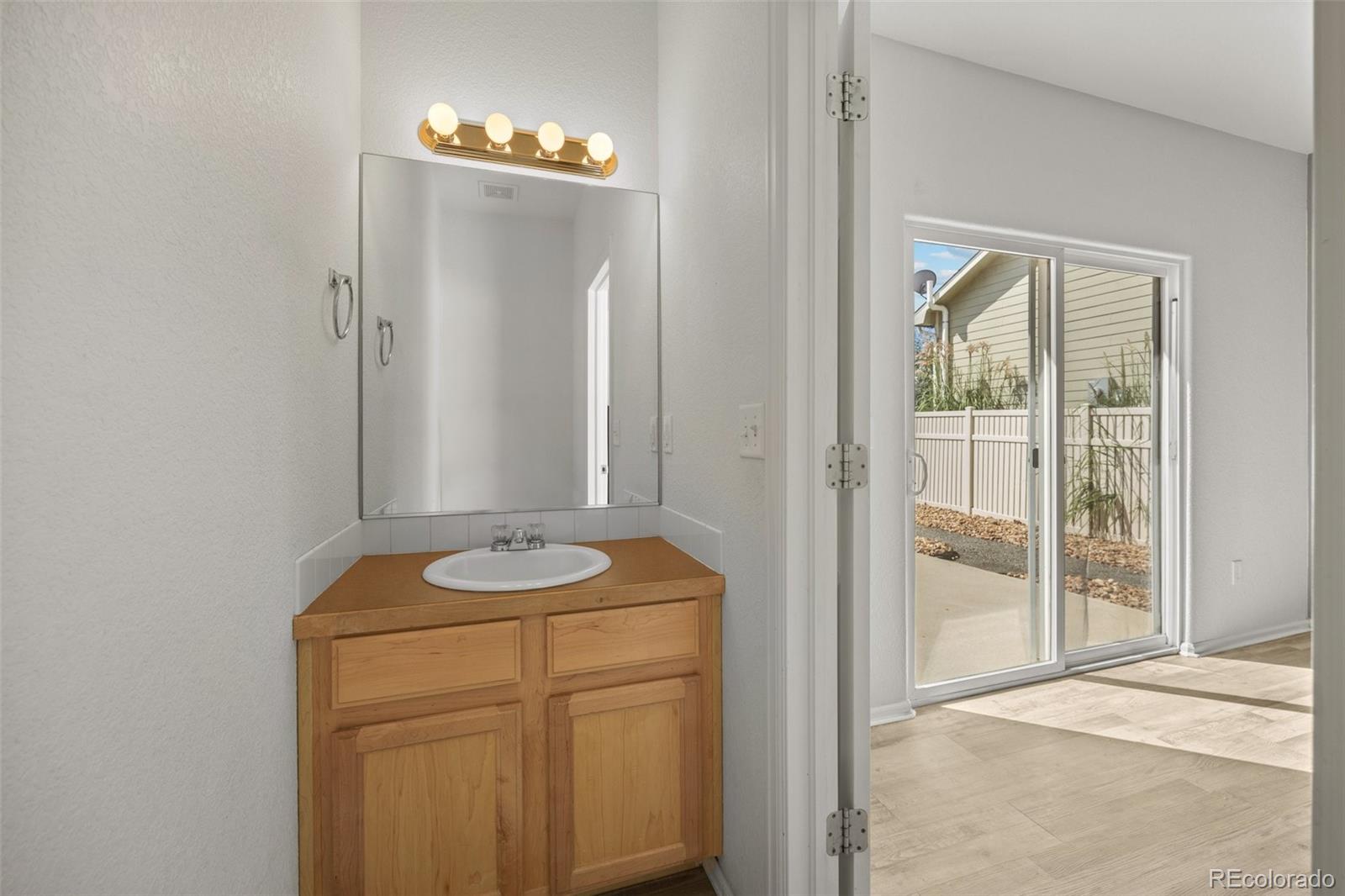 5328 Rustic Avenue Firestone, CO 80504 - Photo 15 of 22 a bathroom with a sink and a mirror