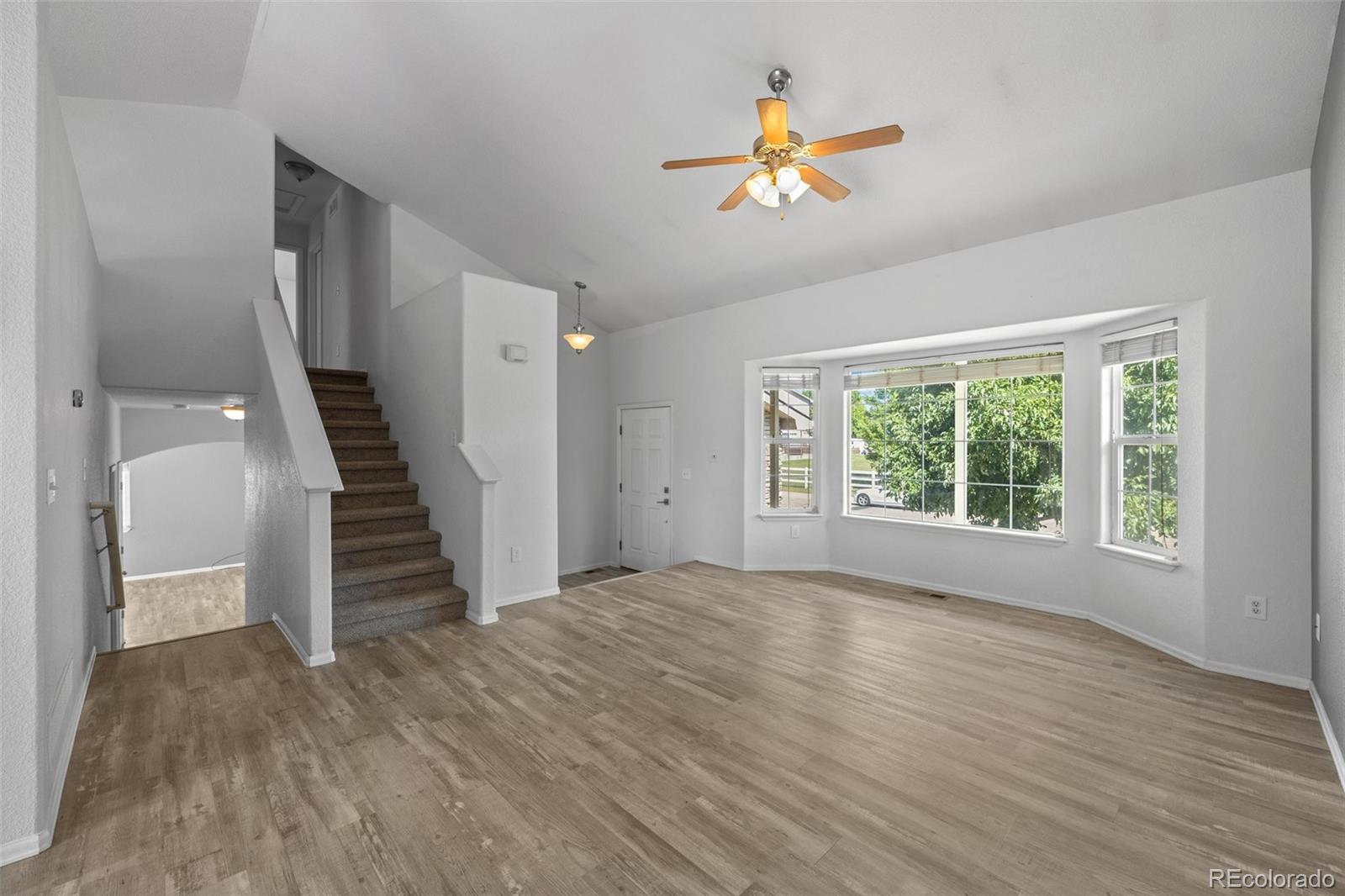 5328 Rustic Avenue Firestone, CO 80504 - Photo 6 of 22 a view of empty room with wooden floor and fan