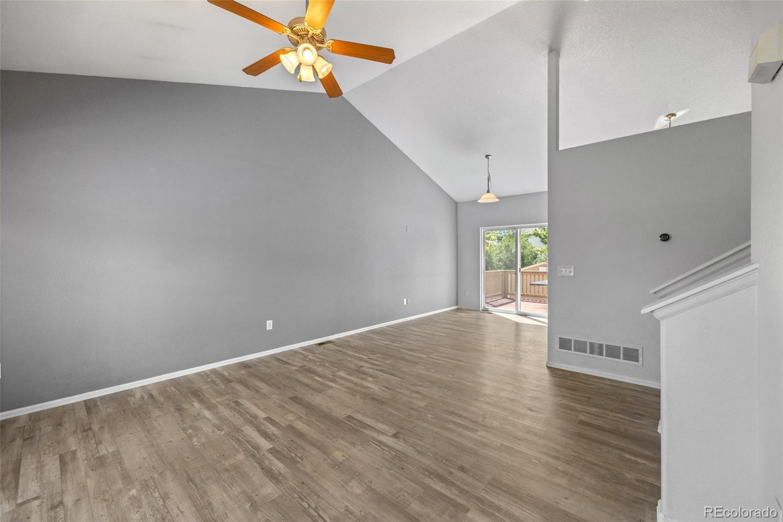 5328 Rustic Avenue Firestone, CO 80504 - Photo 7 of 22 a view of an empty room with window and wooden floor