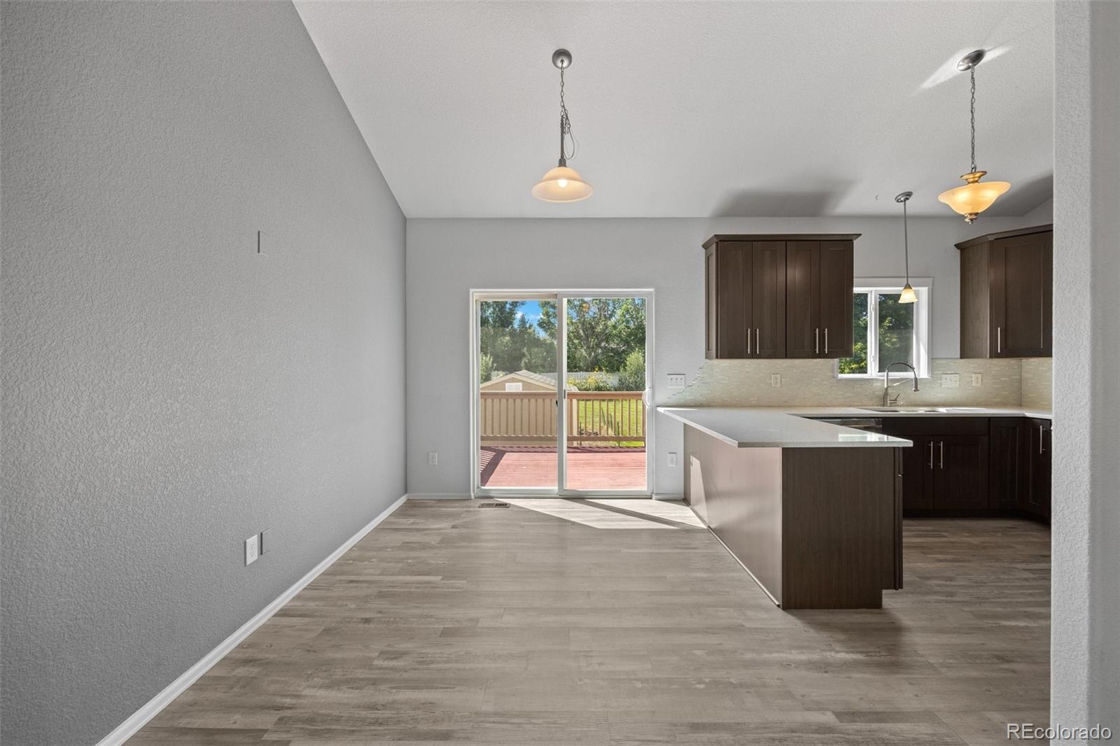 5328 Rustic Avenue Firestone, CO 80504 - Photo 8 of 22 a large kitchen with a large counter top appliances and cabinets