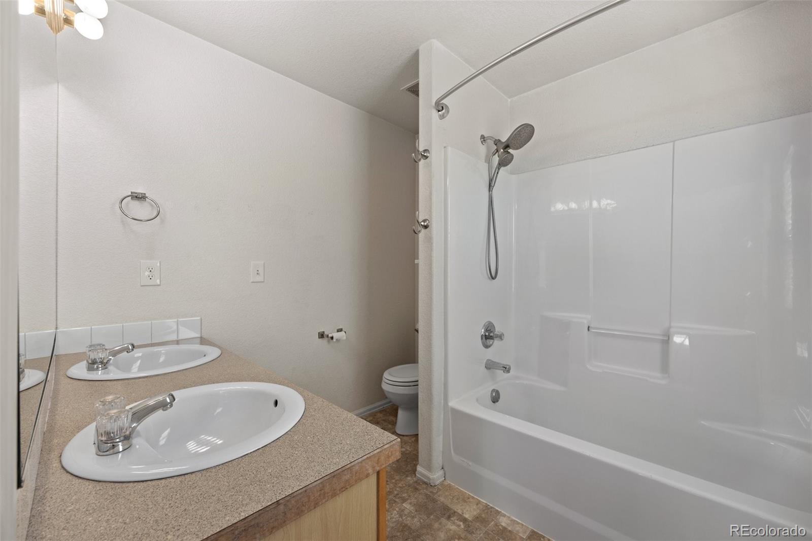 5328 Rustic Avenue Firestone, CO 80504 - Photo 10 of 22 a bathroom with a sink a toilet and shower