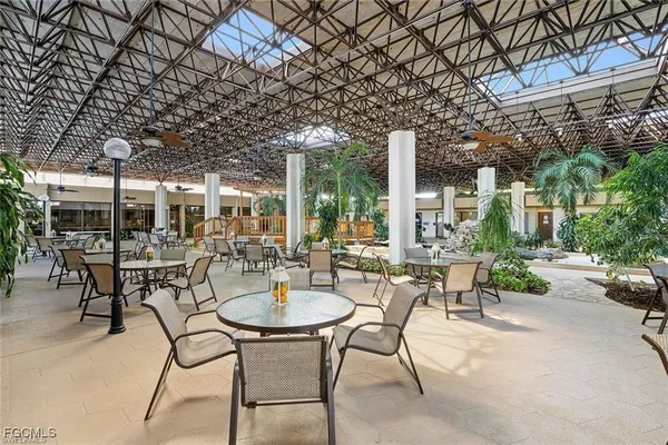 a view of a patio with a table and chairs and potted plants