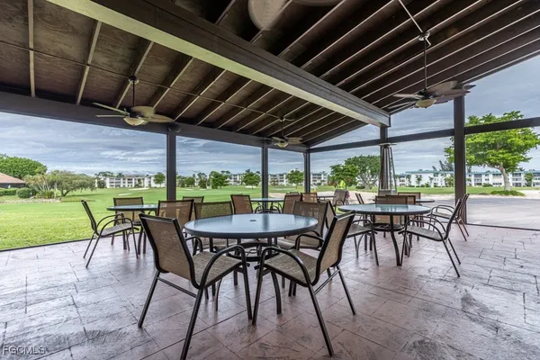 a view of a patio with table and chairs and potted plants