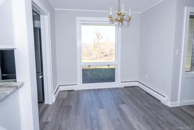a view of a kitchen from a hallway