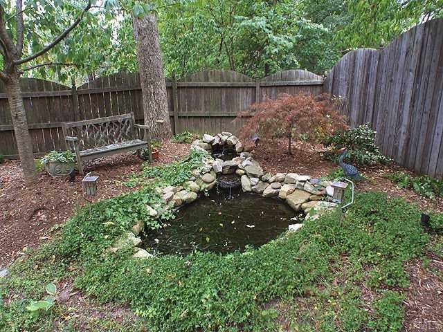 6509 Arbor Grande Way Raleigh, NC 27615 - Photo 11 of 12 Koi pond in the backyard, which is fully fenced, by the way! Read a book on the bench.