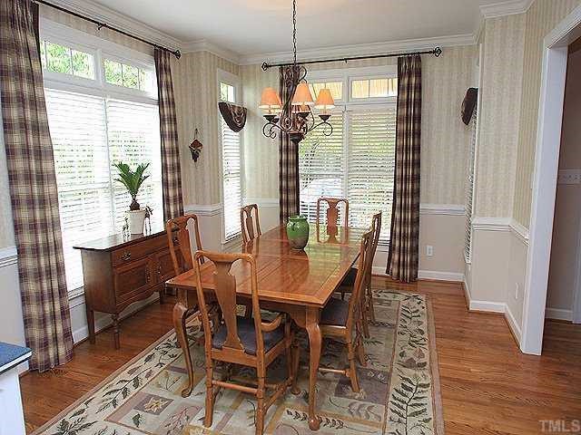 6509 Arbor Grande Way Raleigh, NC 27615 - Photo 3 of 12 Open to kitchen, this dining area has Hardwood floors, wood blinds, chair rail, and transom windows. Lots of natural light!