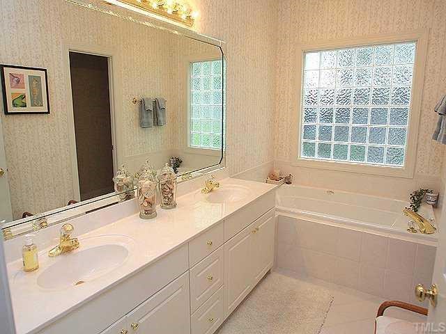 6509 Arbor Grande Way Raleigh, NC 27615 - Photo 6 of 12 Amenities of the master bath include dual vanity, tile floor, tub, and separate shower!