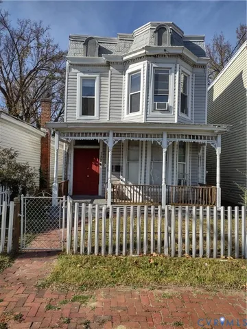 a front view of a house with a fence