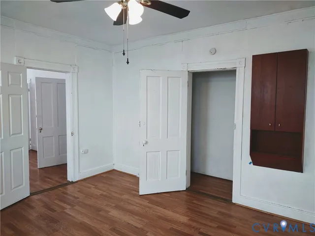a view of empty room with wooden floor