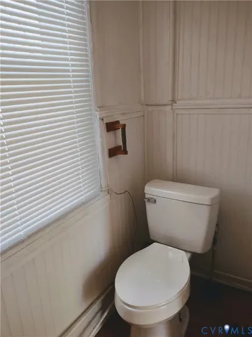 a white toilet sitting next to a white sink