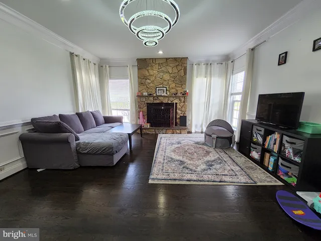 a living room with furniture flat screen tv and a fireplace