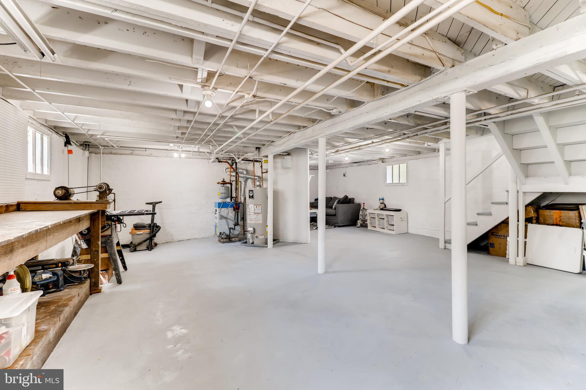 6111 Tramore Road Baltimore, MD 21214 - Photo 25 of 28 Full Basement with Work Bench & NEW Sump Pump