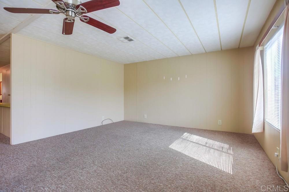 1506 Oak Drive, Unit 22 Vista, CA 92084 - Photo 12 of 58 an empty room with windows and fan