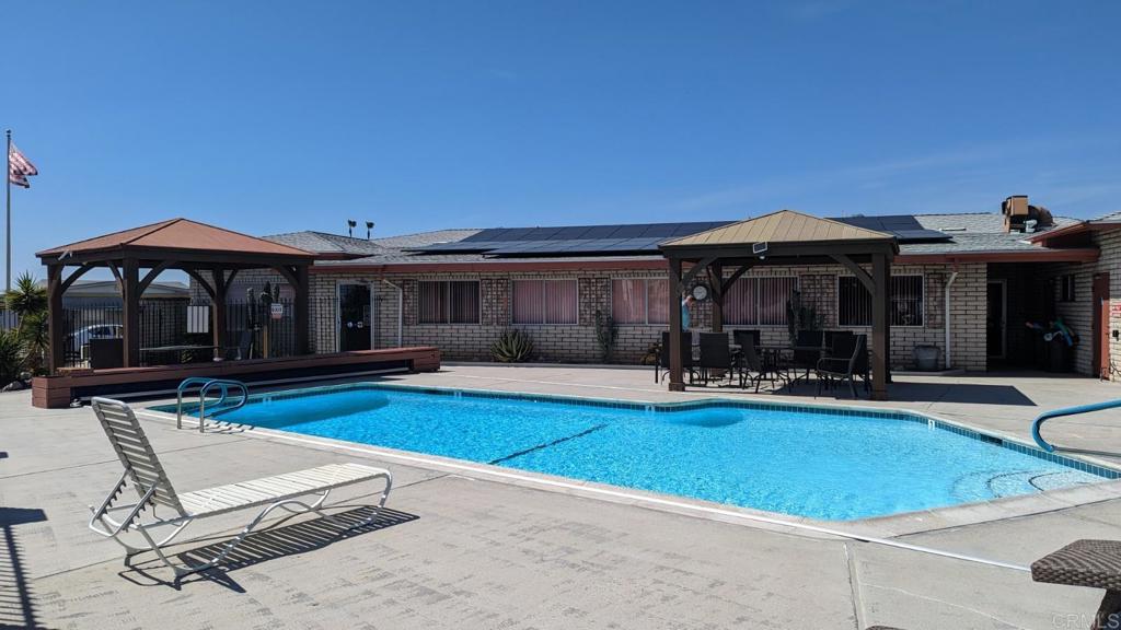 1506 Oak Drive, Unit 22 Vista, CA 92084 - Photo 44 of 58 a view of house with swimming pool and porch with furniture