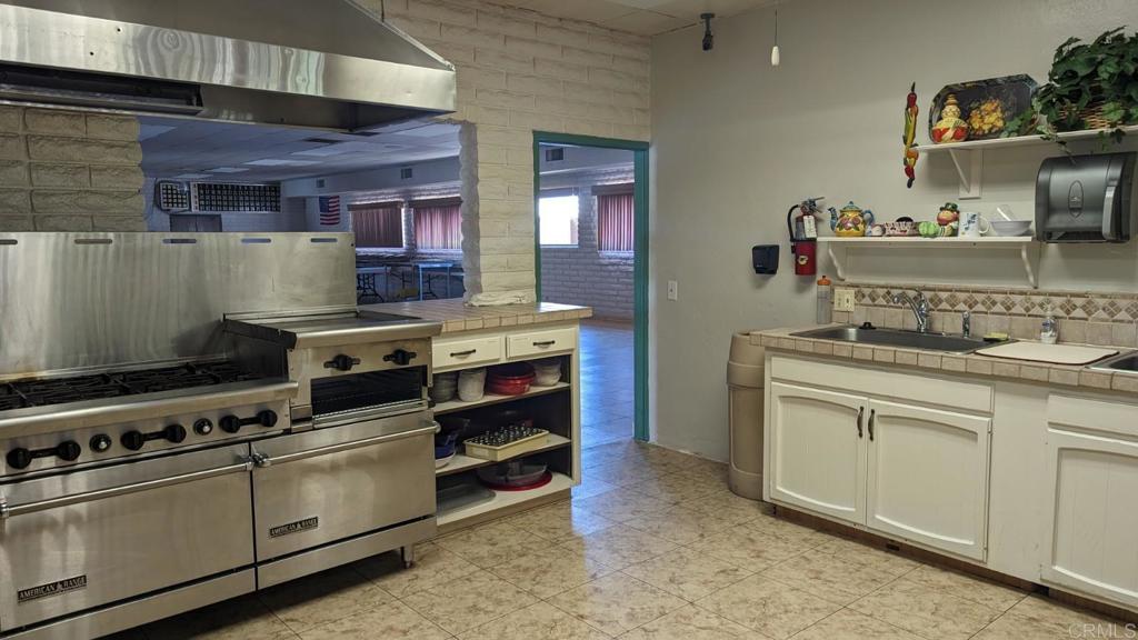 1506 Oak Drive, Unit 22 Vista, CA 92084 - Photo 49 of 58 a kitchen with a stove and a sink