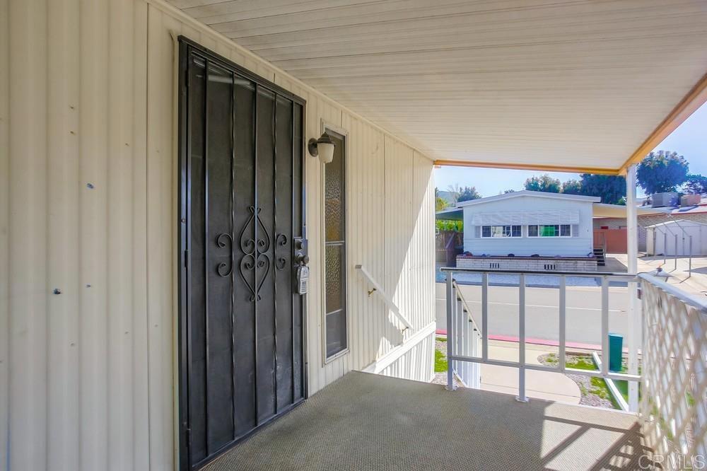 1506 Oak Drive, Unit 22 Vista, CA 92084 - Photo 6 of 58 a view of a bedroom with wooden floor and windows