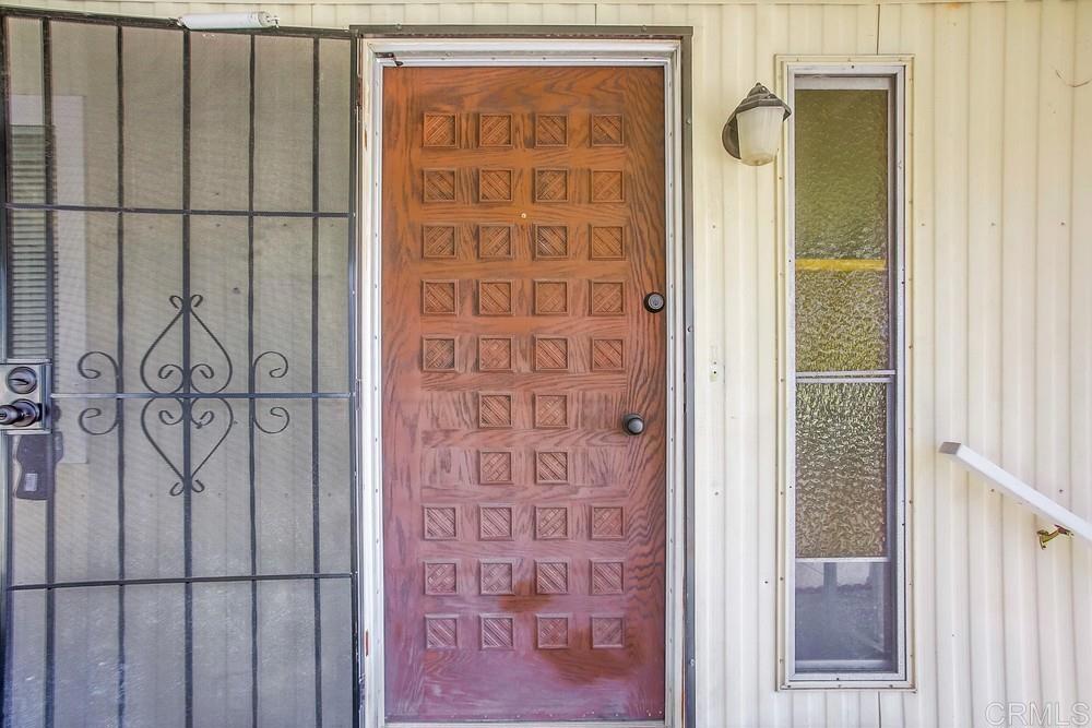 1506 Oak Drive, Unit 22 Vista, CA 92084 - Photo 7 of 58 a view of front door with wooden door