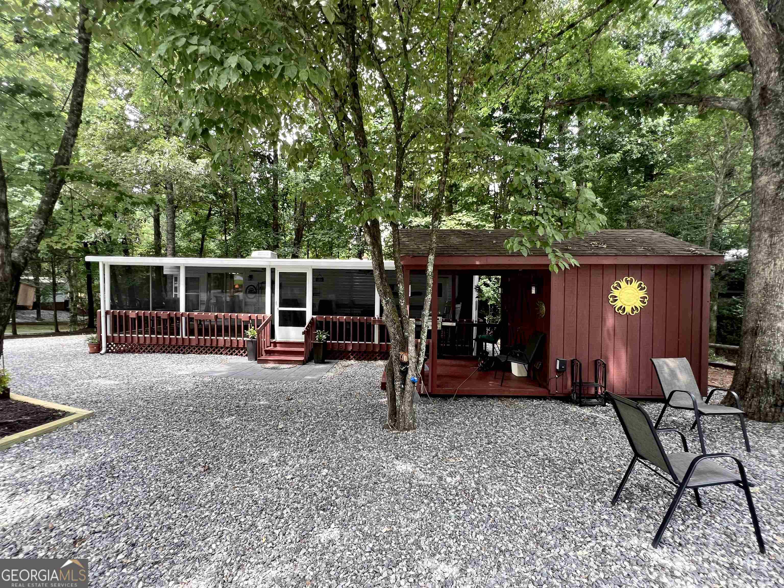 a view of a house with backyard porch and sitting area