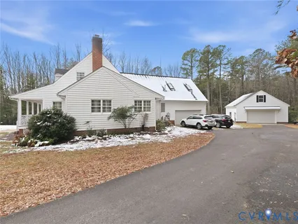 a view of a house with a snow on the road