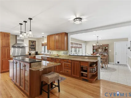 a kitchen with stainless steel appliances a sink stove and wooden cabinets