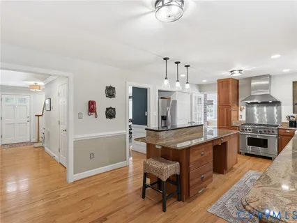 a living room with stainless steel appliances kitchen island granite countertop furniture and a kitchen view