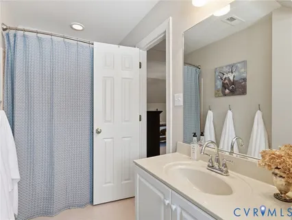 a bathroom with a sink vanity and a mirror