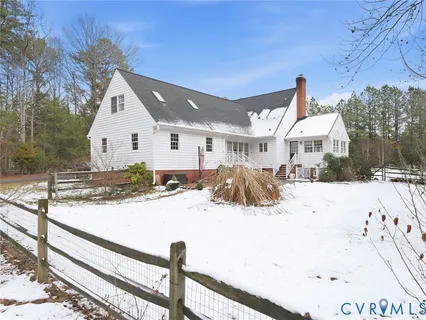 a view of a house with snow on the road