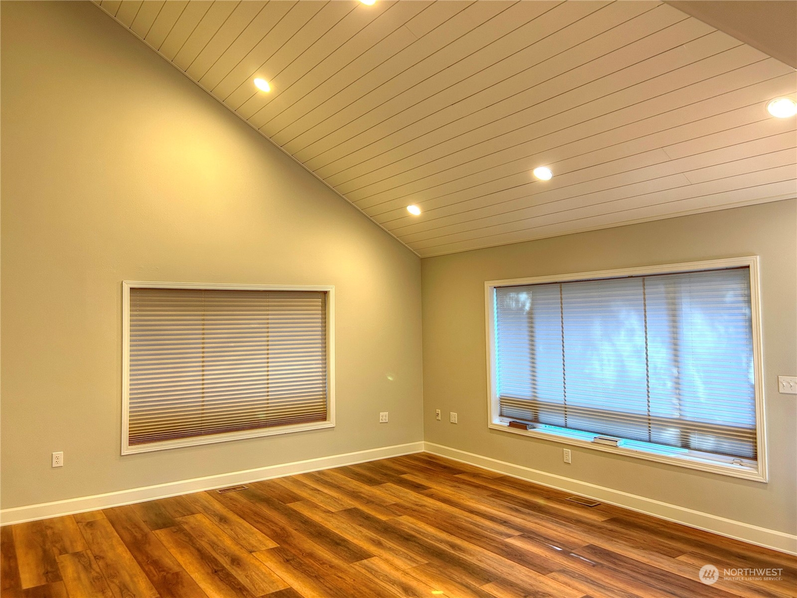 18835 Southeast Petrovitsky Road Renton, WA 98058 - Photo 4 of 34 a view of an empty room with wooden floor and a window