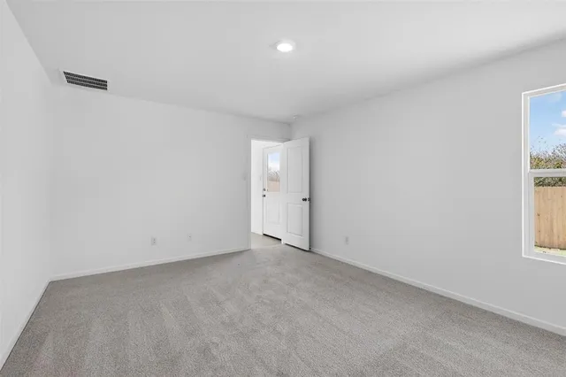 an empty room with windows and natural light