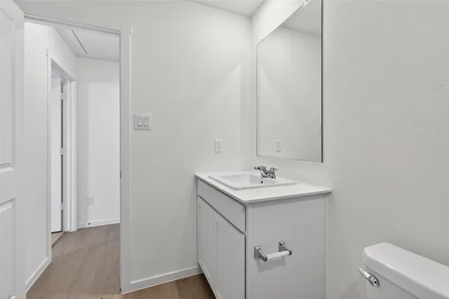 a bathroom with a sink a toilet and a mirror