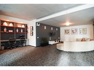 659 West Randolph Street, Unit 1105 Chicago, IL 60661 - Photo 3 of 11 a living room with furniture and a flat screen tv