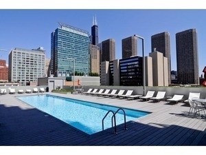659 West Randolph Street, Unit 1105 Chicago, IL 60661 - Photo 4 of 11 a kitchen with a sink cabinets and outdoor space