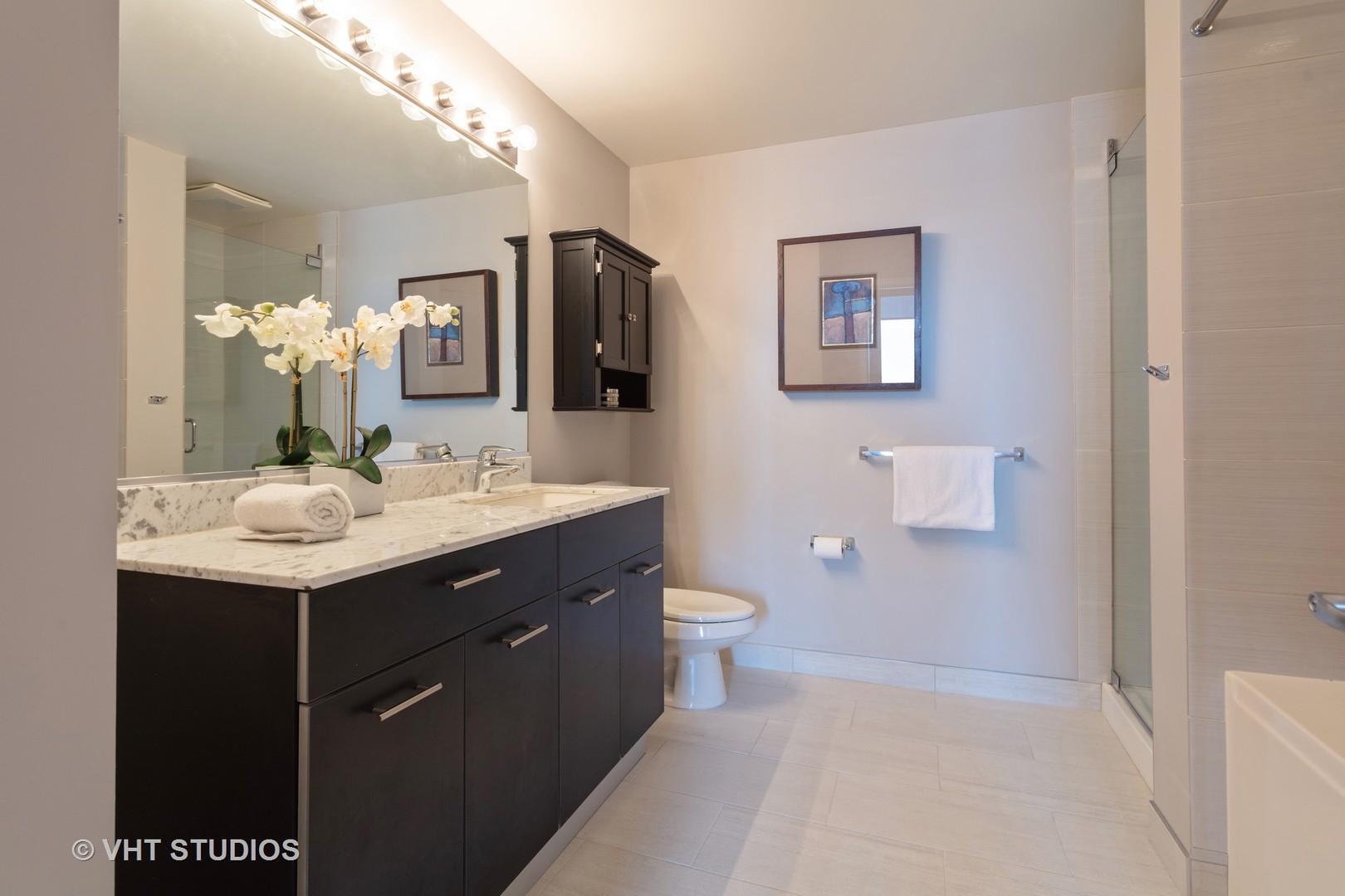 659 West Randolph Street, Unit 1105 Chicago, IL 60661 - Photo 9 of 11 a bathroom with a sink and a mirror