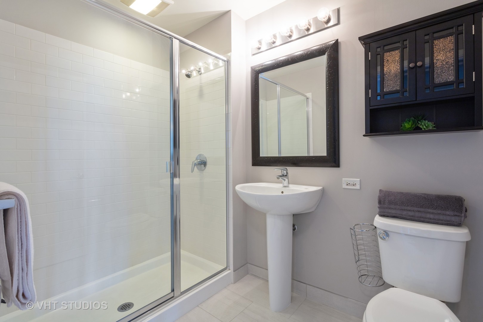 659 West Randolph Street, Unit 1105 Chicago, IL 60661 - Photo 10 of 11 a bathroom with a toilet sink and mirror