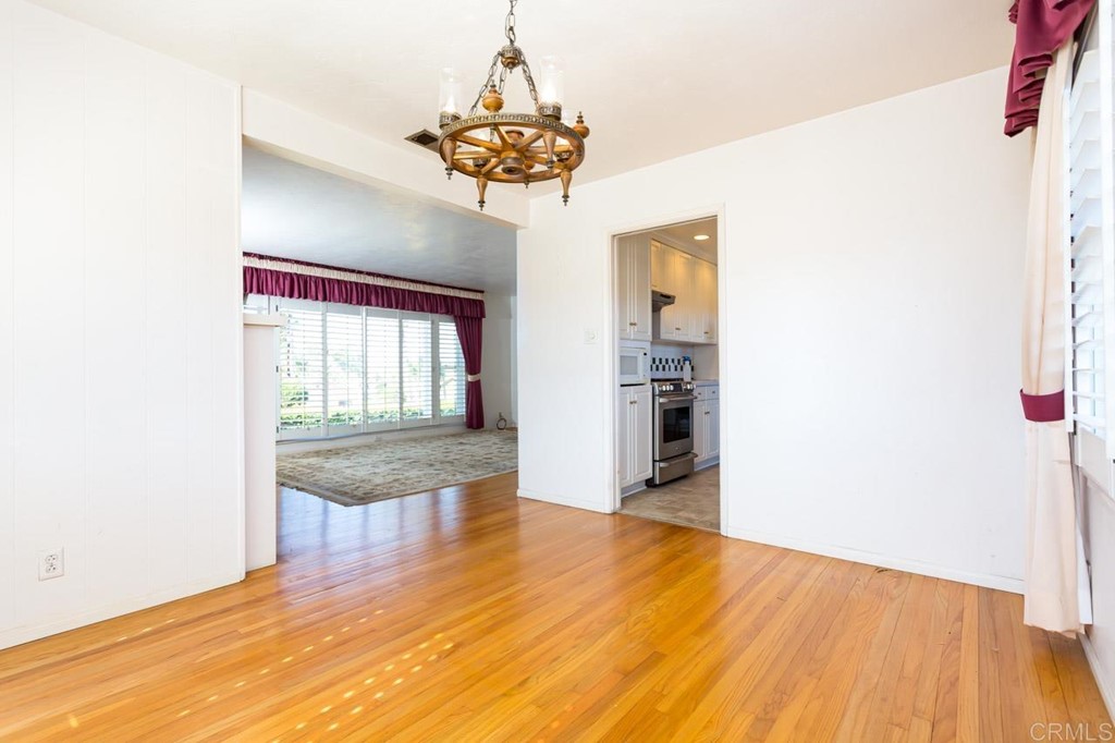 323 Hill Drive Vista, CA 92083 - Photo 11 of 39 a view of an empty room with wooden floor and a window