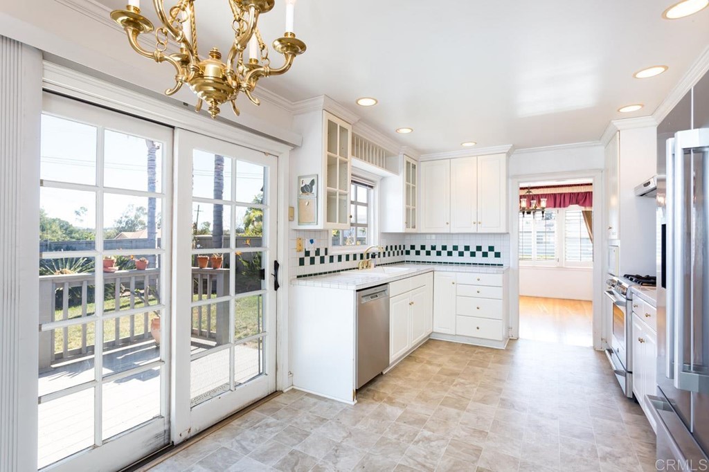323 Hill Drive Vista, CA 92083 - Photo 14 of 39 a kitchen with stainless steel appliances granite countertop a stove a sink and a refrigerator