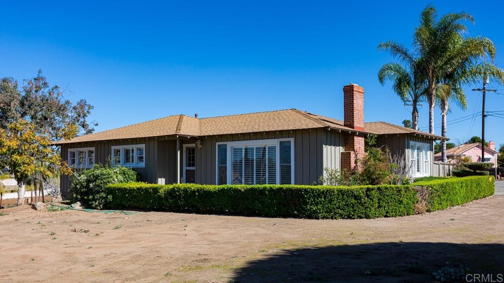 323 Hill Drive Vista, CA 92083 - Photo 3 of 39 a front view of a house with a garden