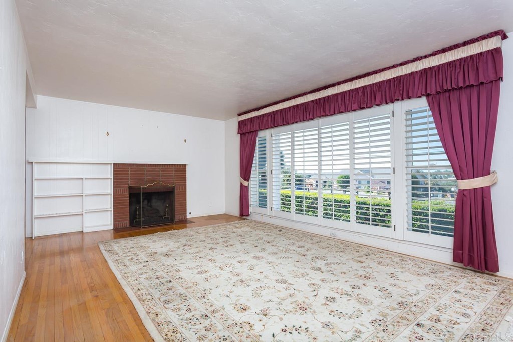323 Hill Drive Vista, CA 92083 - Photo 6 of 39 a view of empty room with floor to ceiling window and fireplace