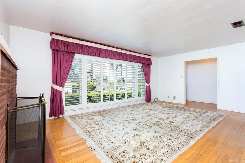 323 Hill Drive Vista, CA 92083 - Photo 8 of 39 a view of empty room with wooden floor and fan