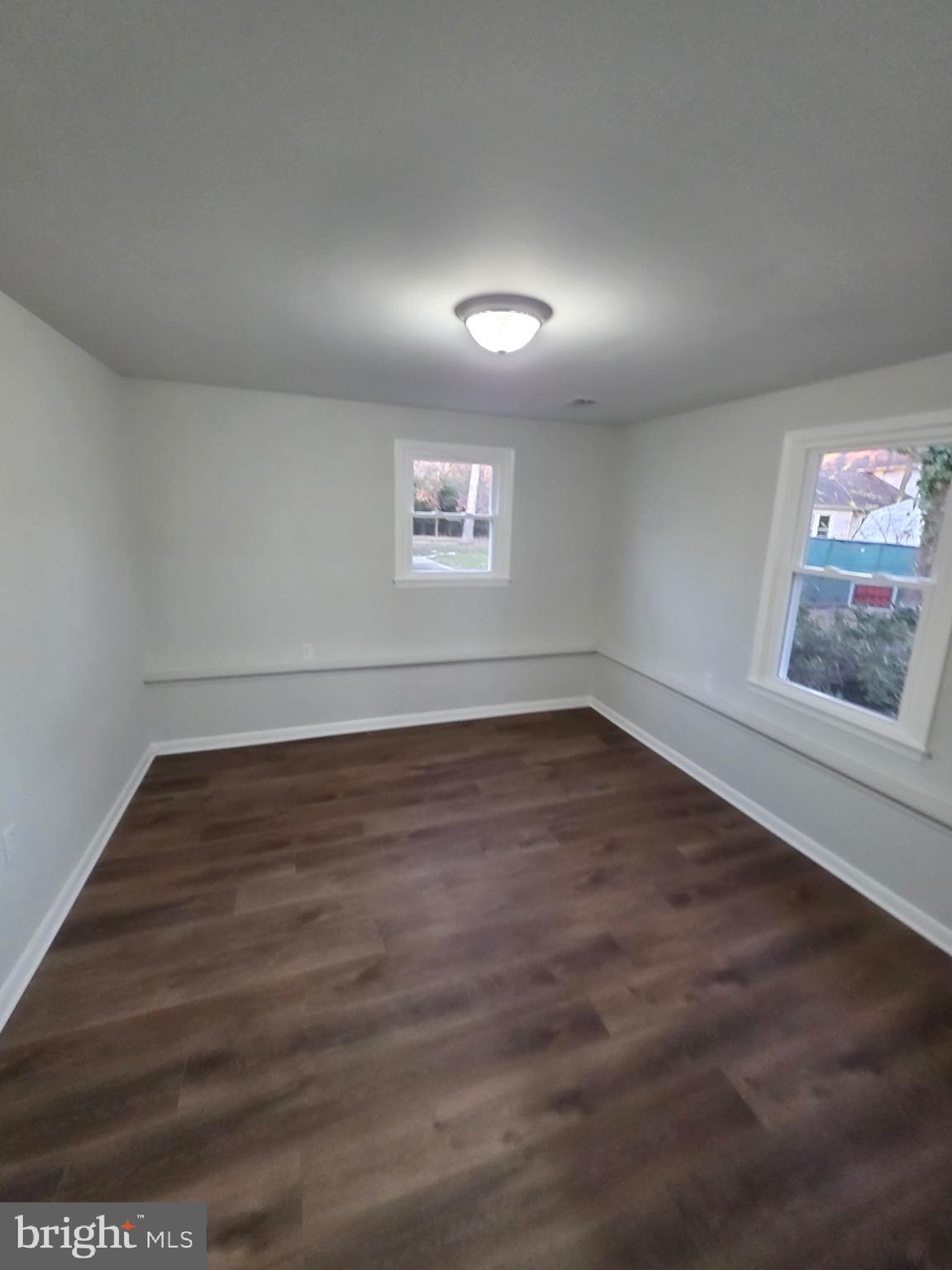 7005 Nightingale Terrace Lanham, MD 20706 - Photo 11 of 23 an empty room with wooden floor and windows