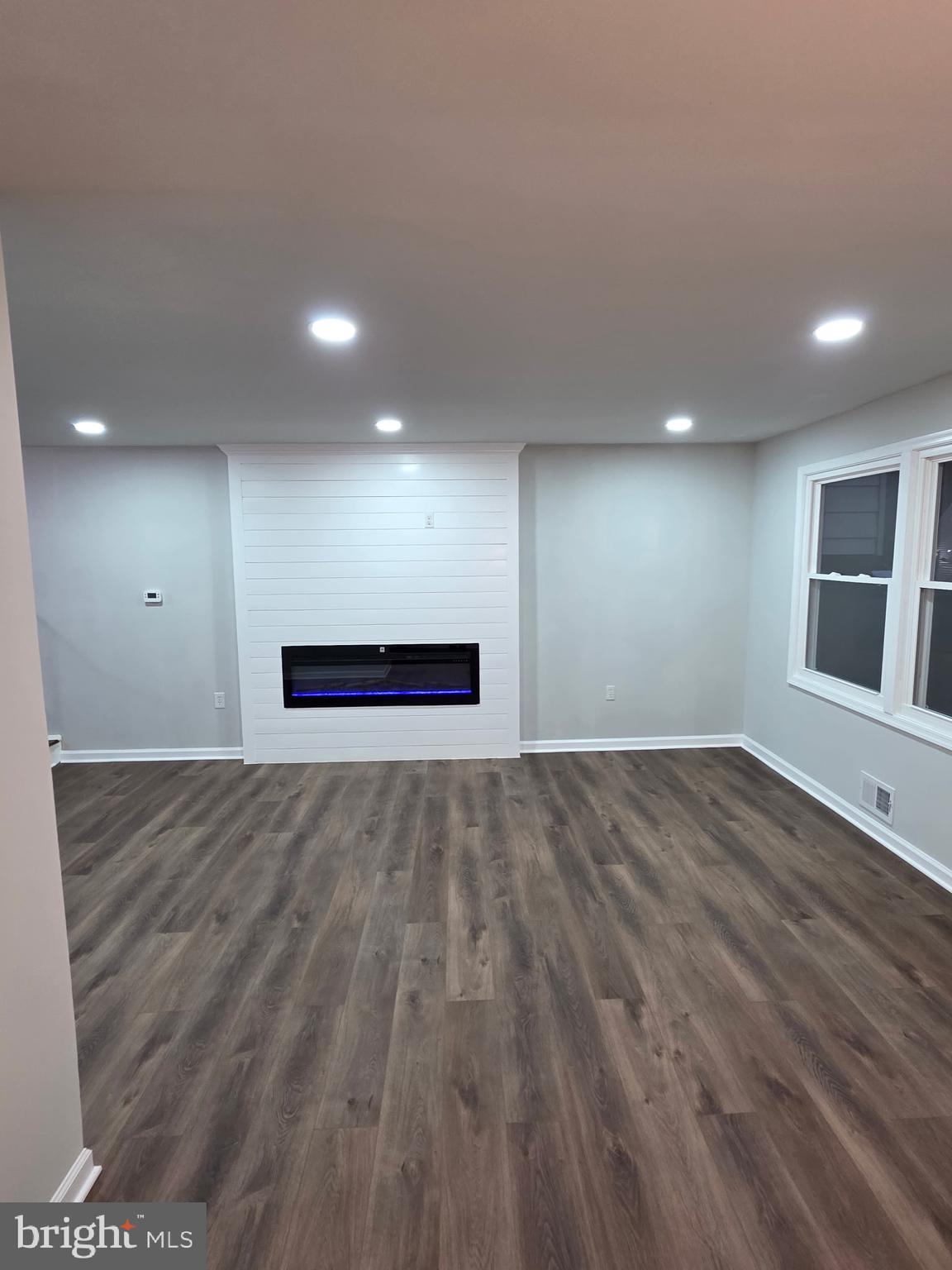 7005 Nightingale Terrace Lanham, MD 20706 - Photo 16 of 23 a view of an empty room with wooden floor and windows