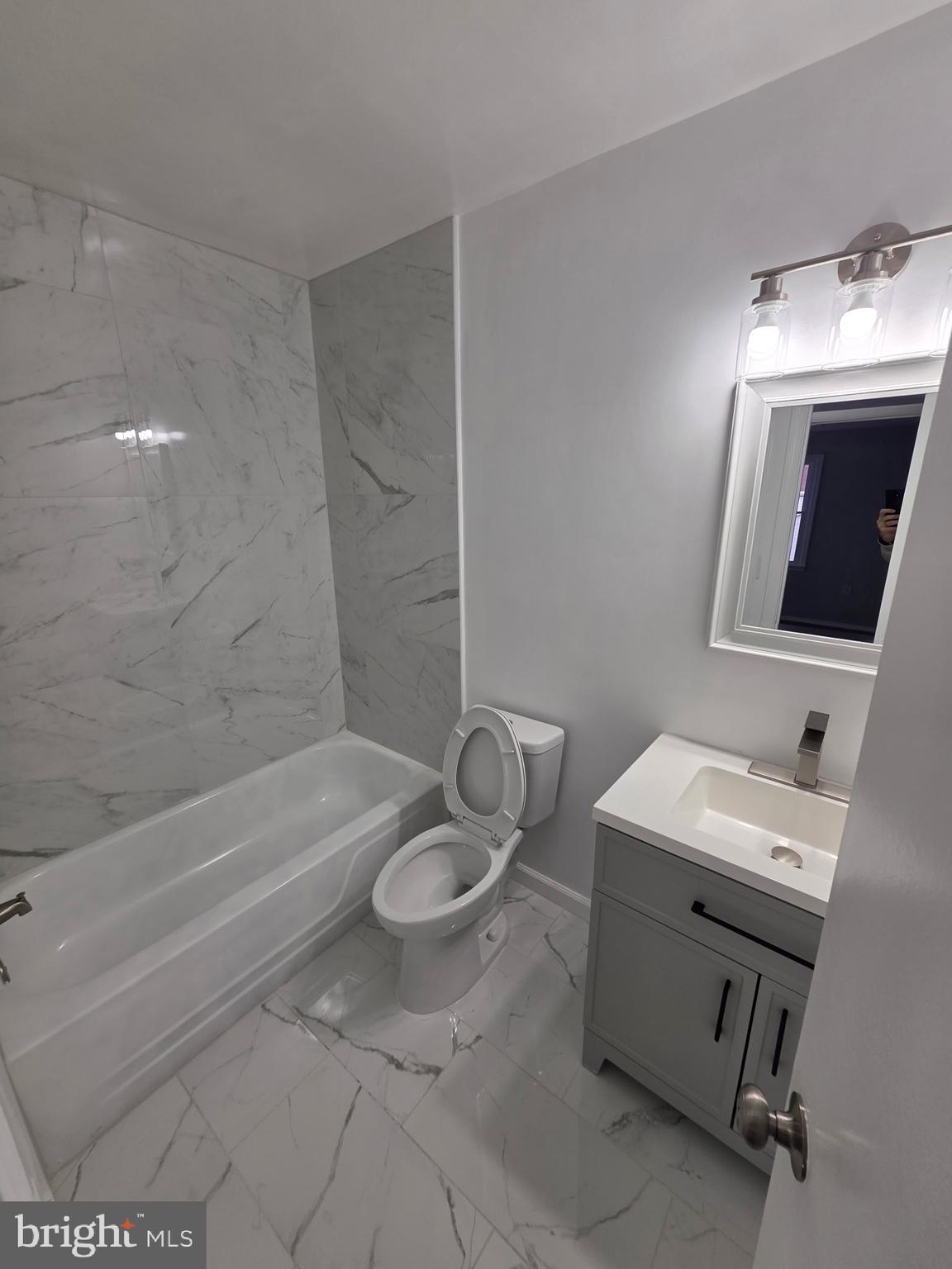 7005 Nightingale Terrace Lanham, MD 20706 - Photo 20 of 23 a bathroom with a sink toilet a mirror and bathtub