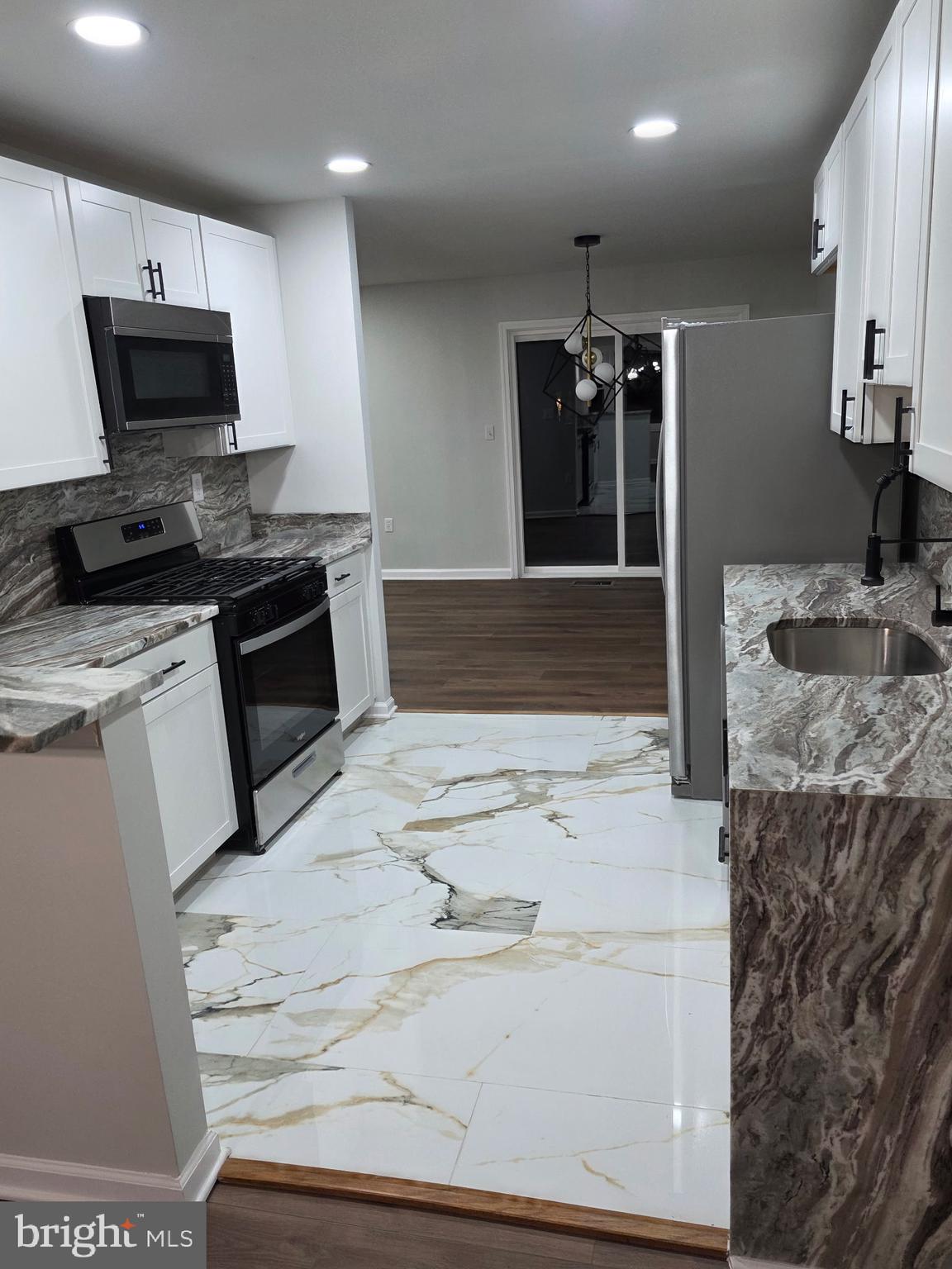7005 Nightingale Terrace Lanham, MD 20706 - Photo 2 of 23 a kitchen with a sink stove and refrigerator