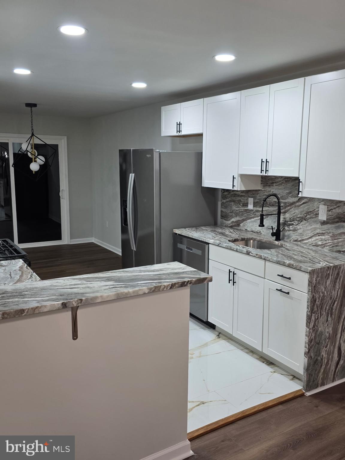 7005 Nightingale Terrace Lanham, MD 20706 - Photo 3 of 23 a kitchen with a sink a refrigerator and a stove