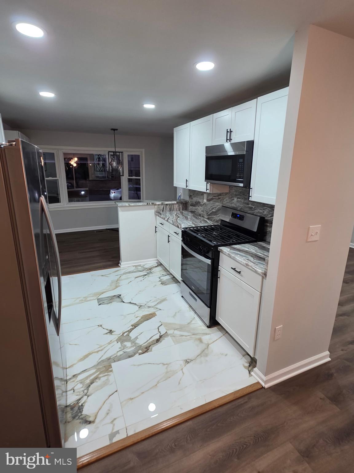 7005 Nightingale Terrace Lanham, MD 20706 - Photo 4 of 23 a kitchen with stainless steel appliances a stove a sink and a refrigerator
