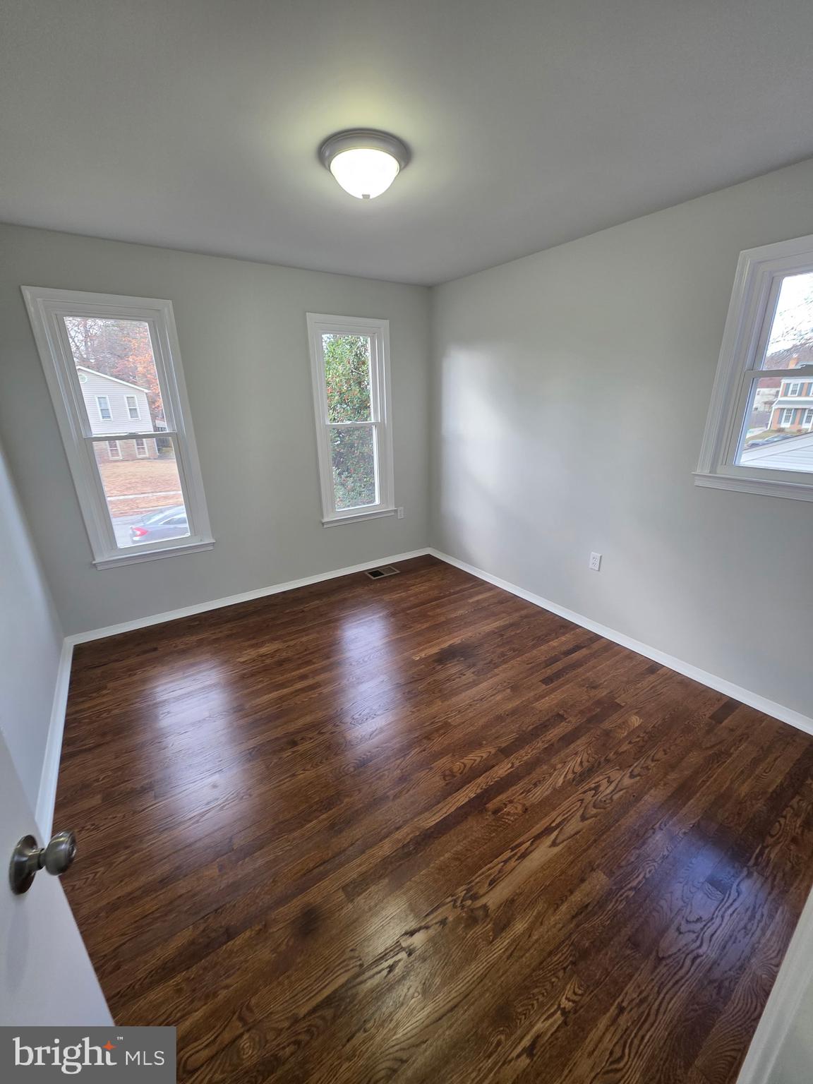 7005 Nightingale Terrace Lanham, MD 20706 - Photo 9 of 23 an empty room with wooden floor and windows