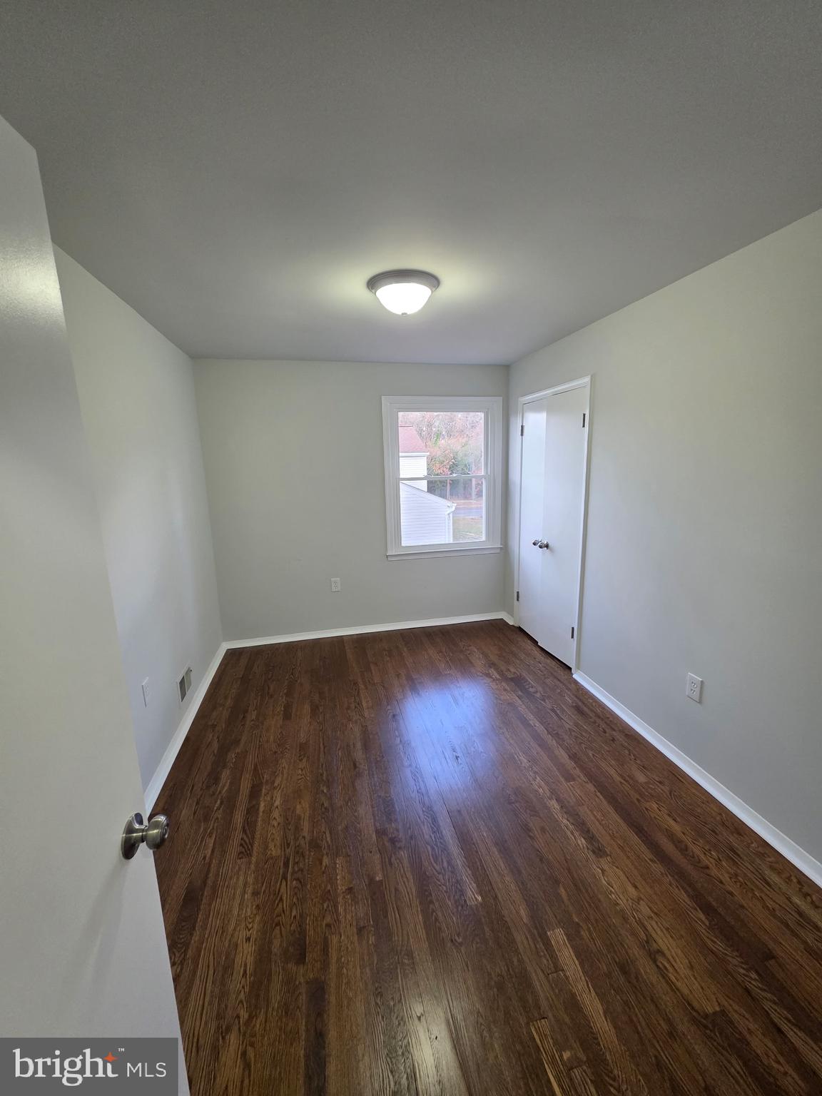 7005 Nightingale Terrace Lanham, MD 20706 - Photo 10 of 23 an empty room with wooden floor and windows