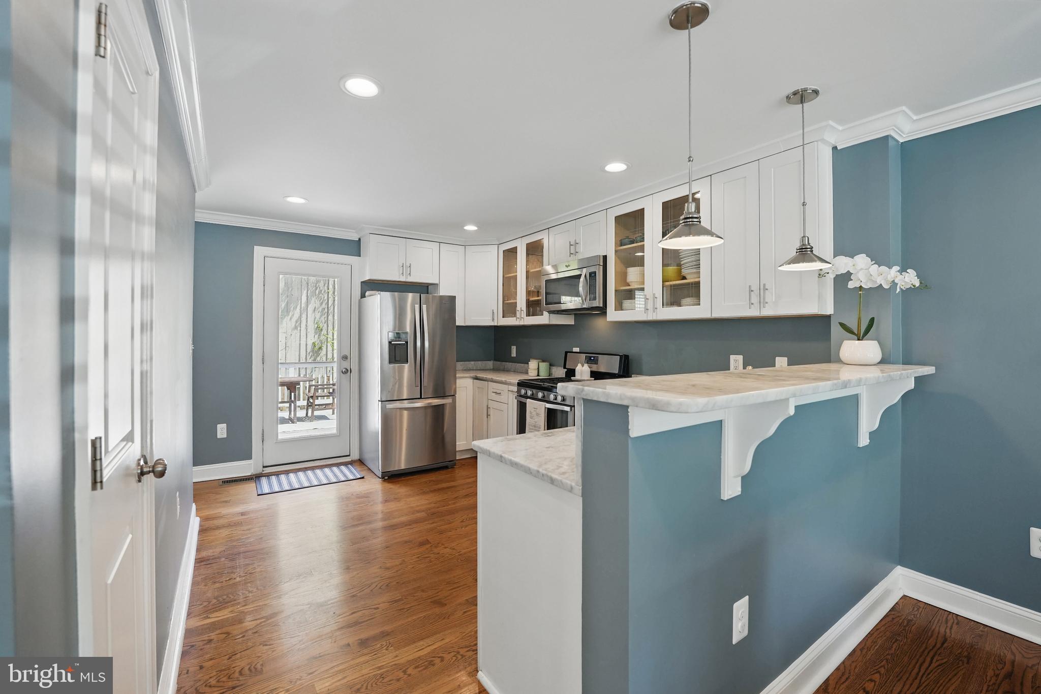 6930 27th Road North Arlington, VA 22213 - Photo 13 of 51 a kitchen with stainless steel appliances granite countertop a refrigerator a oven a sink a stove and white cabinets with wooden floor