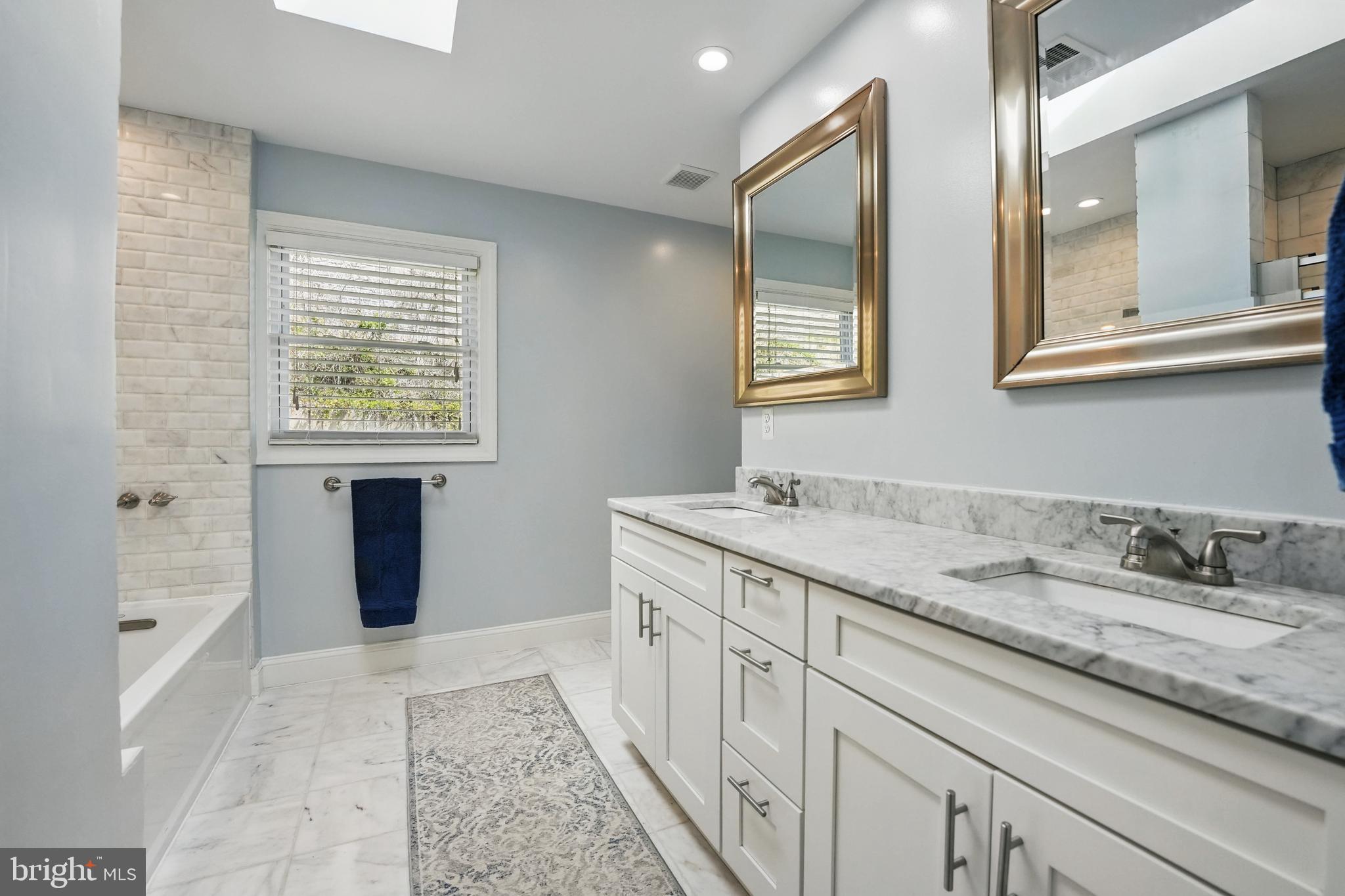 6930 27th Road North Arlington, VA 22213 - Photo 25 of 51 a bathroom with a granite countertop sink a mirror and a bathtub