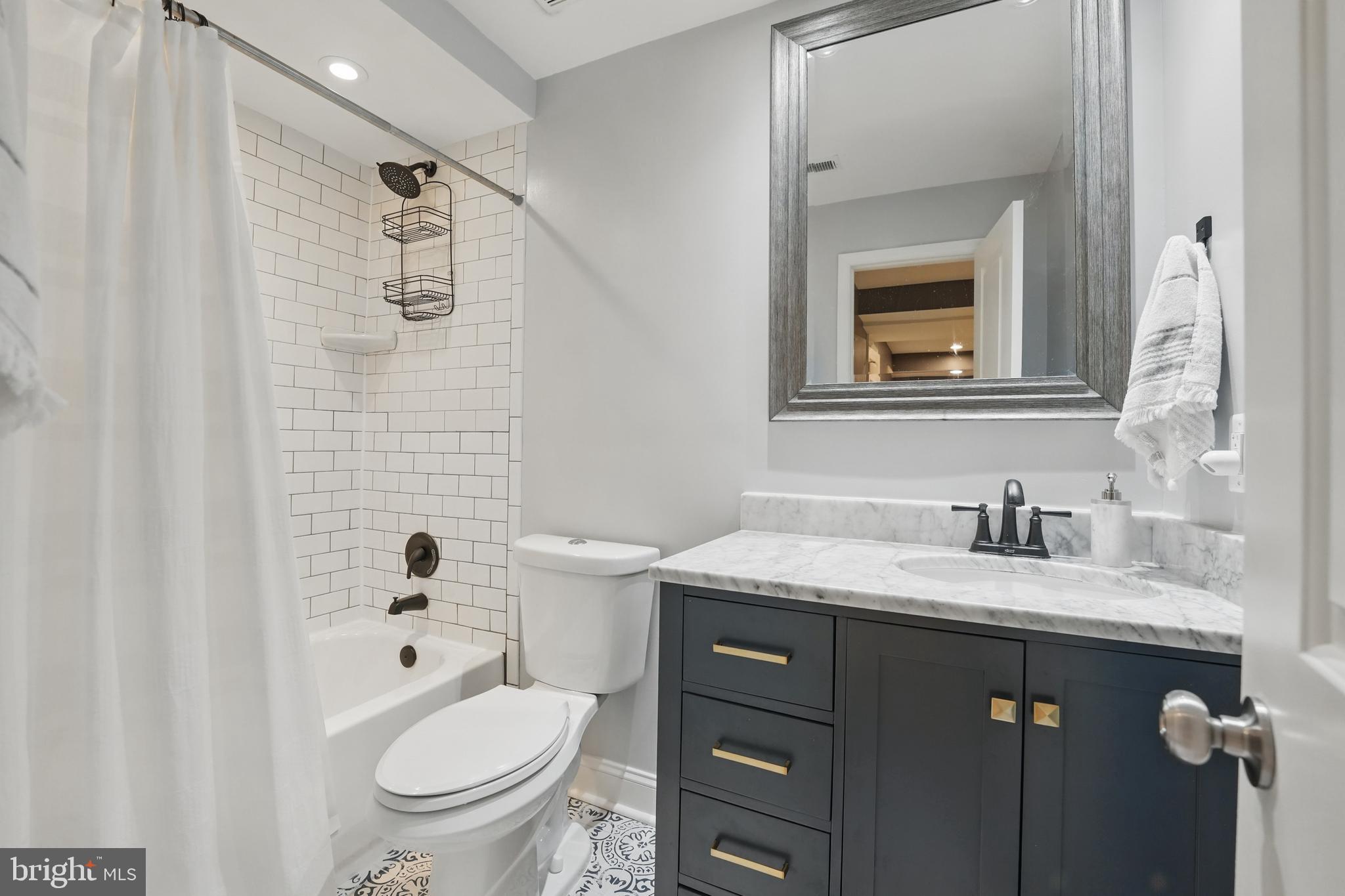 6930 27th Road North Arlington, VA 22213 - Photo 40 of 51 a bathroom with a granite countertop toilet sink and mirror